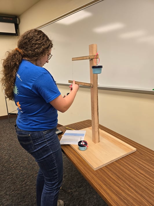 Female Student Competing In Weight Engineering Event