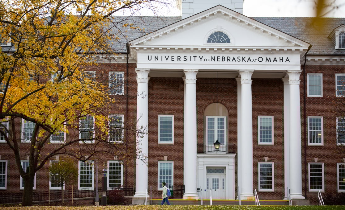 Arts and Sciences building with fall tree