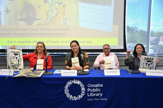 presenters holding books