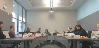 students seated around conference table