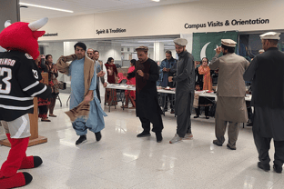 TEA participants of Fall 2022 invite the UNO mascot, Durango, to join in a cultural dance during Culture Day on campus.