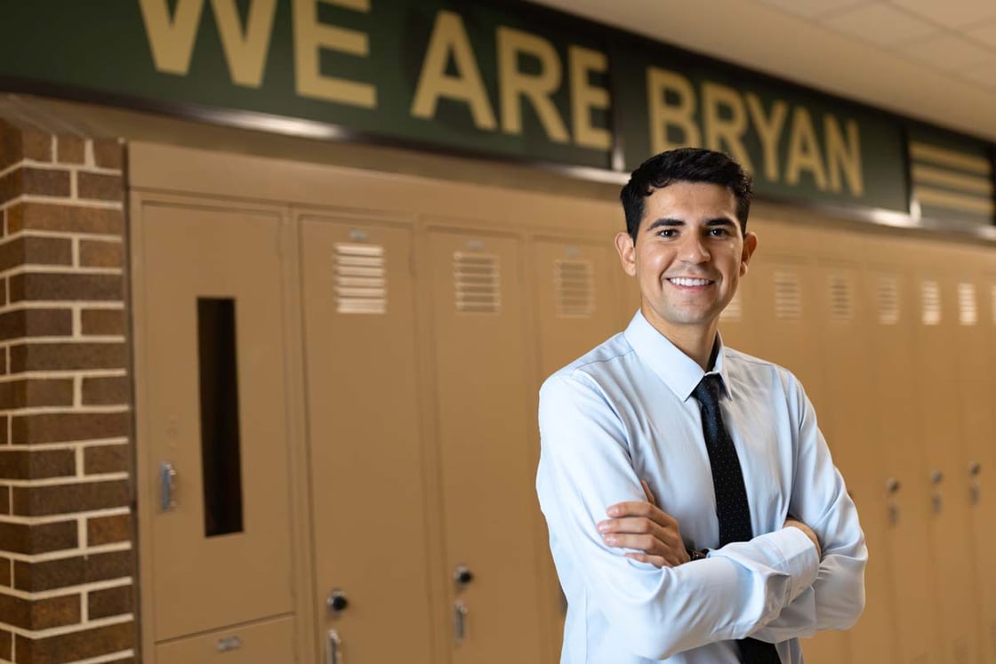Dario Gudino stands in the hallway of Bryan High School