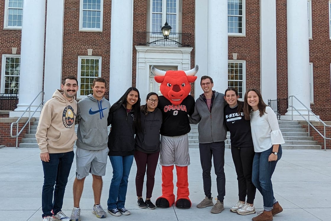 Group of students stand with UNO mascot Durango in front of the Arts and Sciences Building