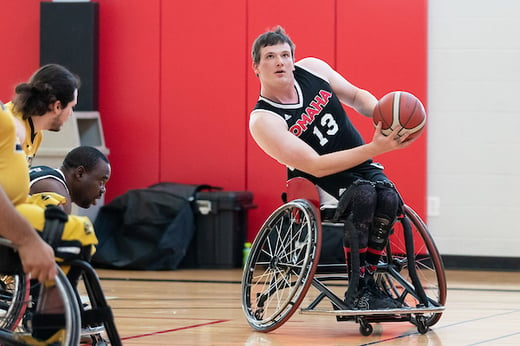 Matt Schultz holds a basketball during a game