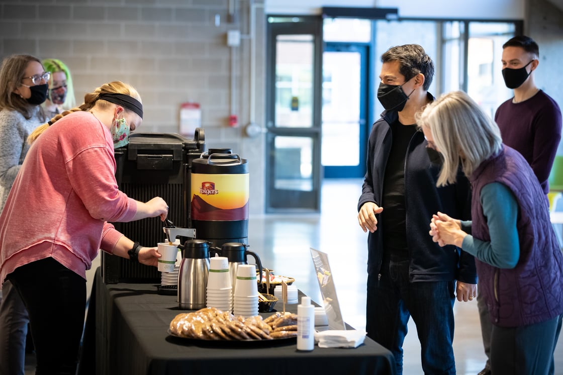 CFE faculty/staff members serving refreshments to faculty/staff at Strauss
