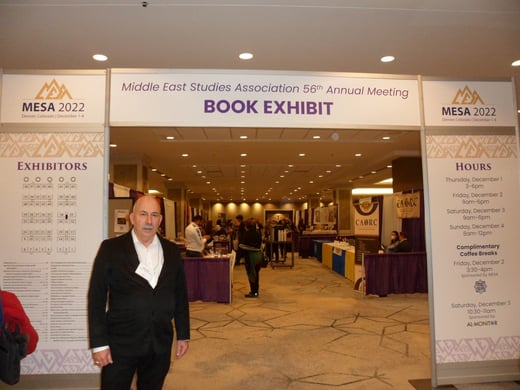 Dr. James Clark stands outside a book exhibit at the MESA conference