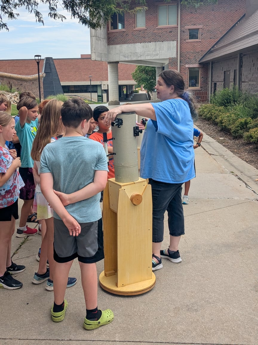 Planetarium Coordinator teaching camp kids about outside light