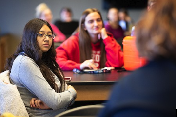 UNO students listen to an instructor in class.