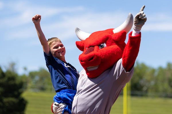Six-year-old Logan Smith celebrates after defeating Durango in a rematch footrace
