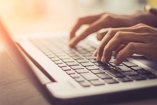 Typing on a laptop