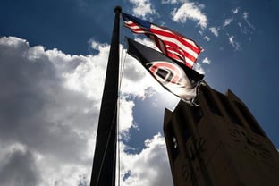 UComm -- MDBE -- campanile flags sun behind