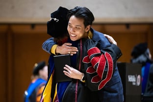 Chancellor Li hugs a student during the 2023 Student Honors Convocation