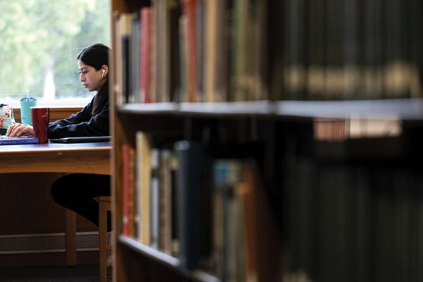 student in library at table