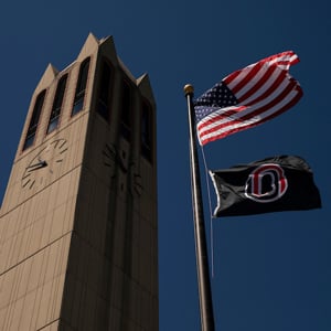 looking up at the Campanile, American flag and UNO flag