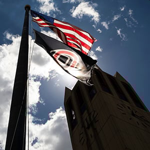 flag campanile sun behind