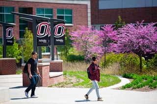 Students walk on campus during late Spring