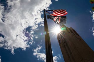 American, UNO flags fly by the campanille