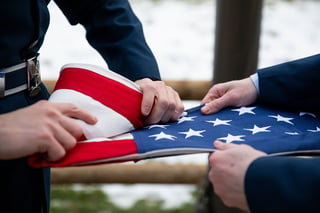 Two ROTC students fold the American flag.