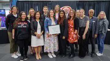 Photo of Alisha Olson, Senior Practicum Specialist for the Grace Abbott School of Social Work at the University of Nebraska at Omaha, alongside many members of the Grace Abbott School of Social Work, UNO Chancellor Li, and NU President Gold.