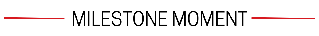 Milestone Moment text centered between two horizontal red lines on a light gray background.