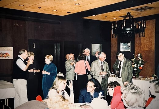 people gathered in an event hall, standing and sitting