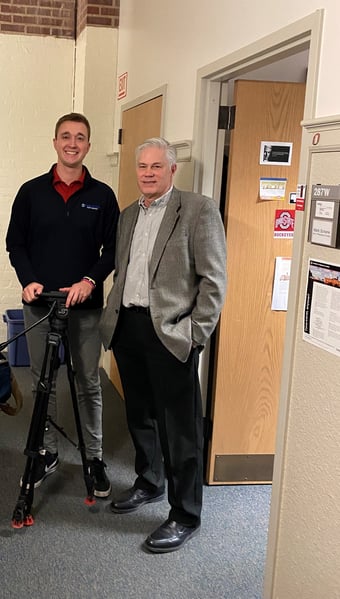 Dr. Mark Scherer stands outside his office with Cal Larsen