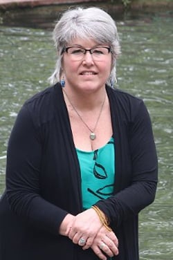 Dr. Jeanne Reames stands in front of a river