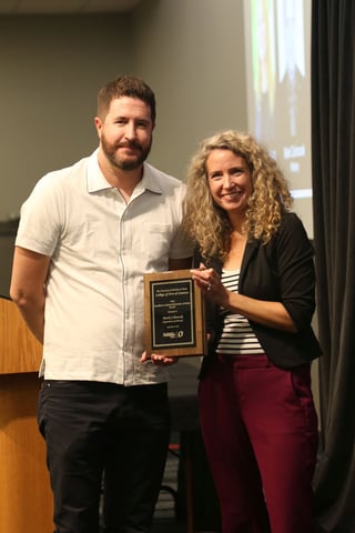 Dean Bloom and Dr. Mark Celinscak pose behind Dr. Celinscak's plaque