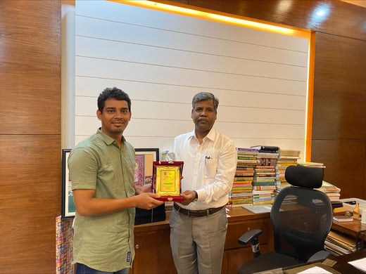 Showkot and Dr. Basir holding an award