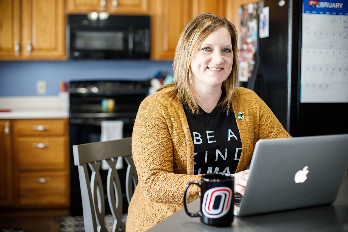 BMS student exploring degrees on her laptop at her kitchen table